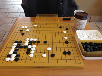 The stones in action on my folding go board at a coffee shop!