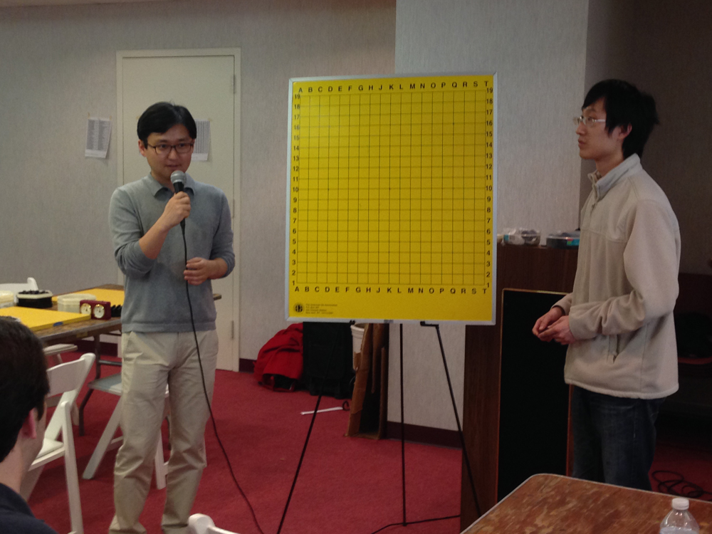 Myung and Andy prepare to review his game.