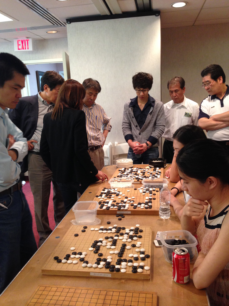 Here you can see a group of Korean players analyzing the board at the far end.